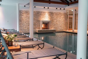 Indoor pool, open 7:00 AM to 10:00 PM, pool loungers