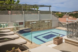 Seasonal outdoor pool, open 10:00 AM to 7:00 PM, pool umbrellas