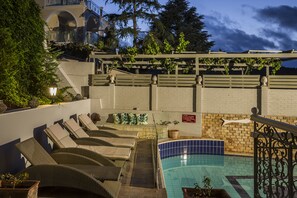Seasonal outdoor pool, open 10:00 AM to 7:00 PM, pool umbrellas