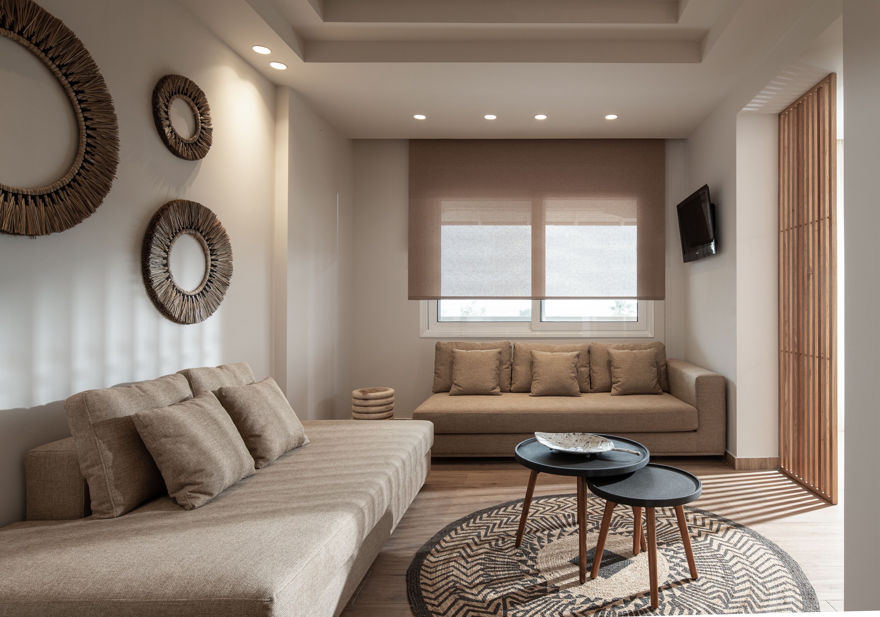 A modern living room with a sofa, a coffee table, and decorative wall art.