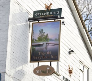 A sign for Greene King Bury St Edmunds, The Old Ferry Boat Inn, with a scenic river view. - Old Ferry Boat St Ives by Greene King Inns (St Ives)