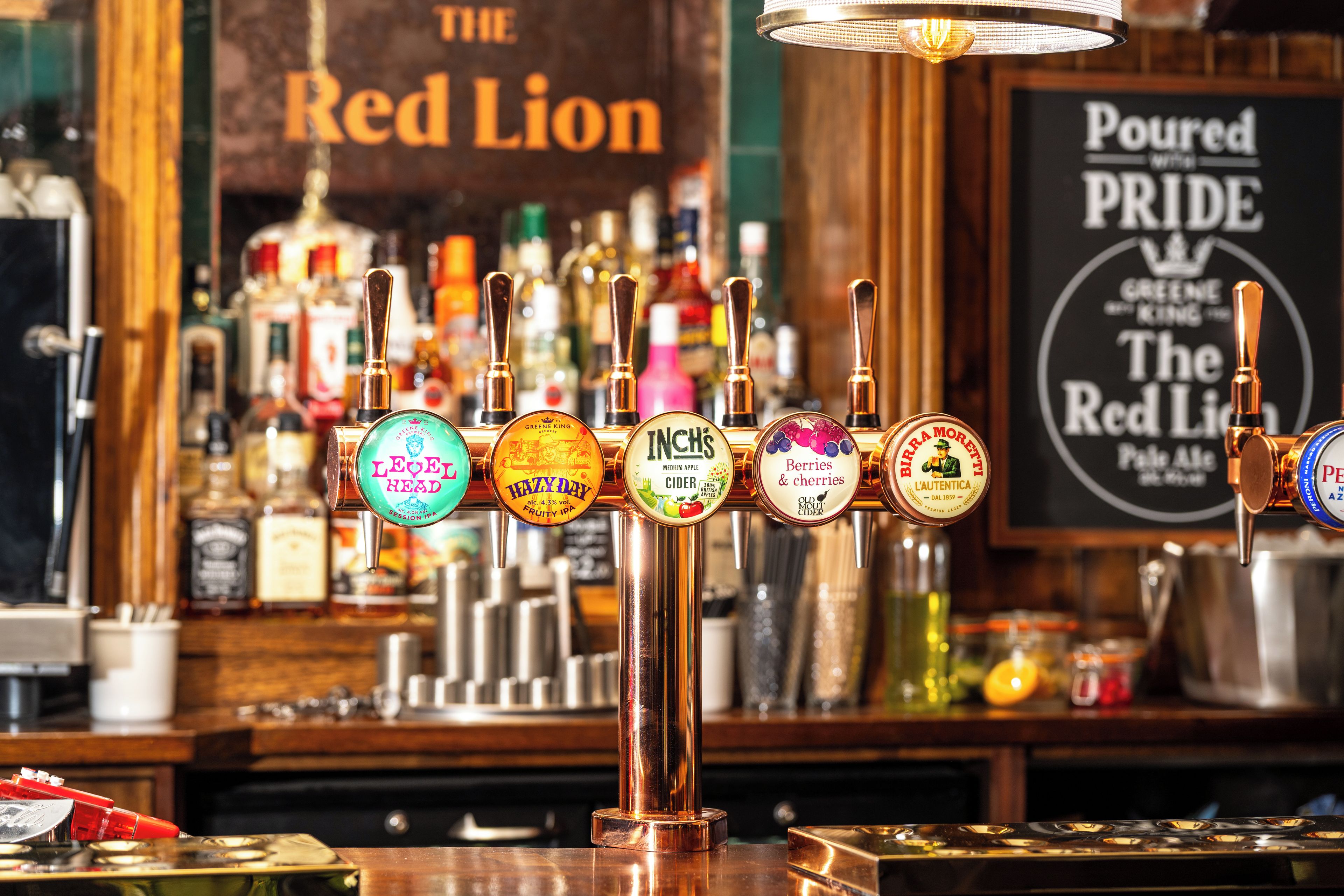 A bar with a tap system displaying various beer brands.