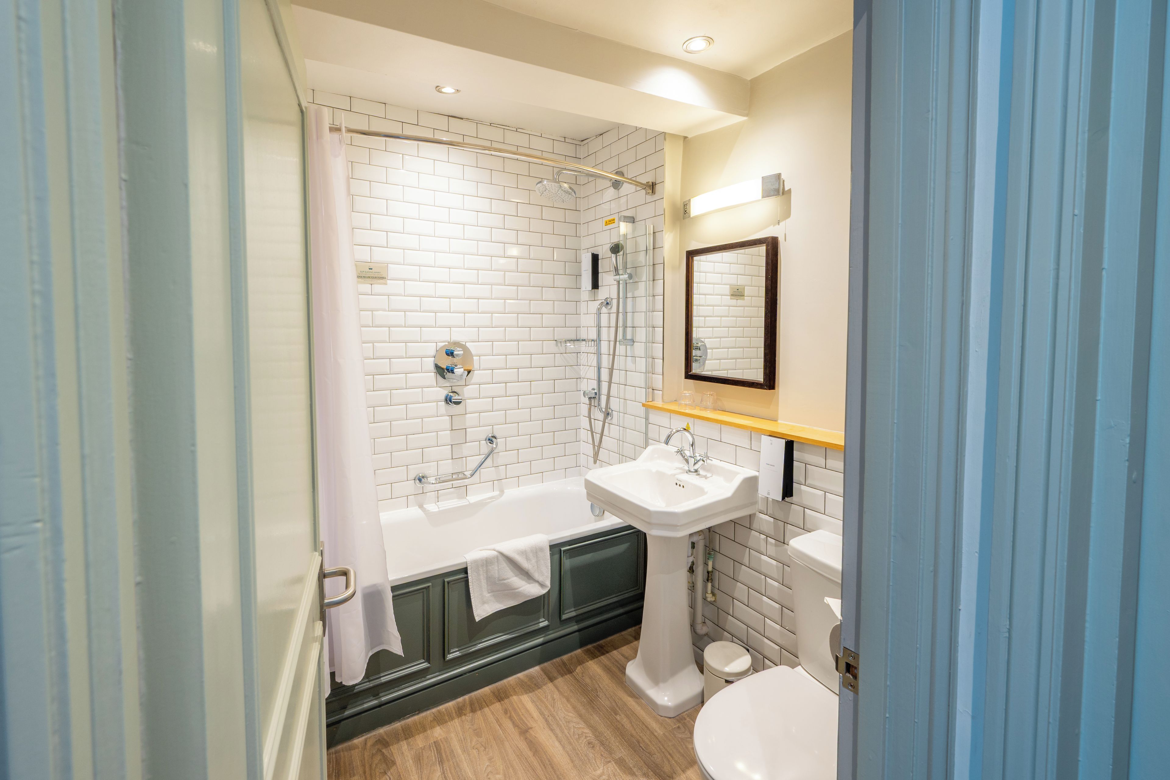 A bathroom with a bathtub, a sink, and a toilet.