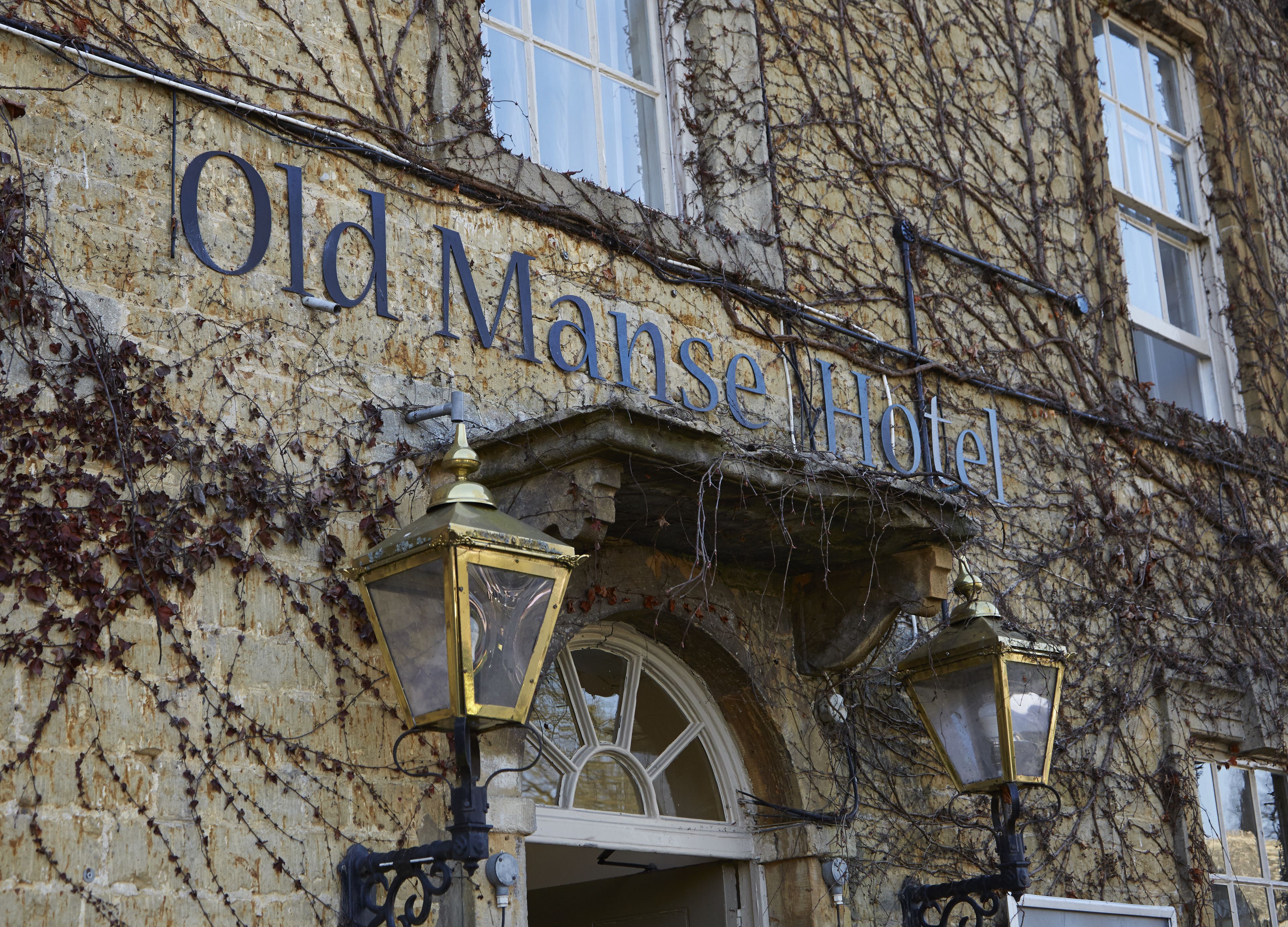 The exterior of the Old Mans House Hotel with ivy-covered walls and a classic arched entrance.