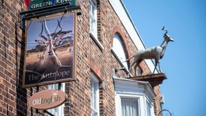 A brick building with a sign for 'The Antelope' and a statue of a deer. - Antelope Hotel by Greene King Inns (Poole)