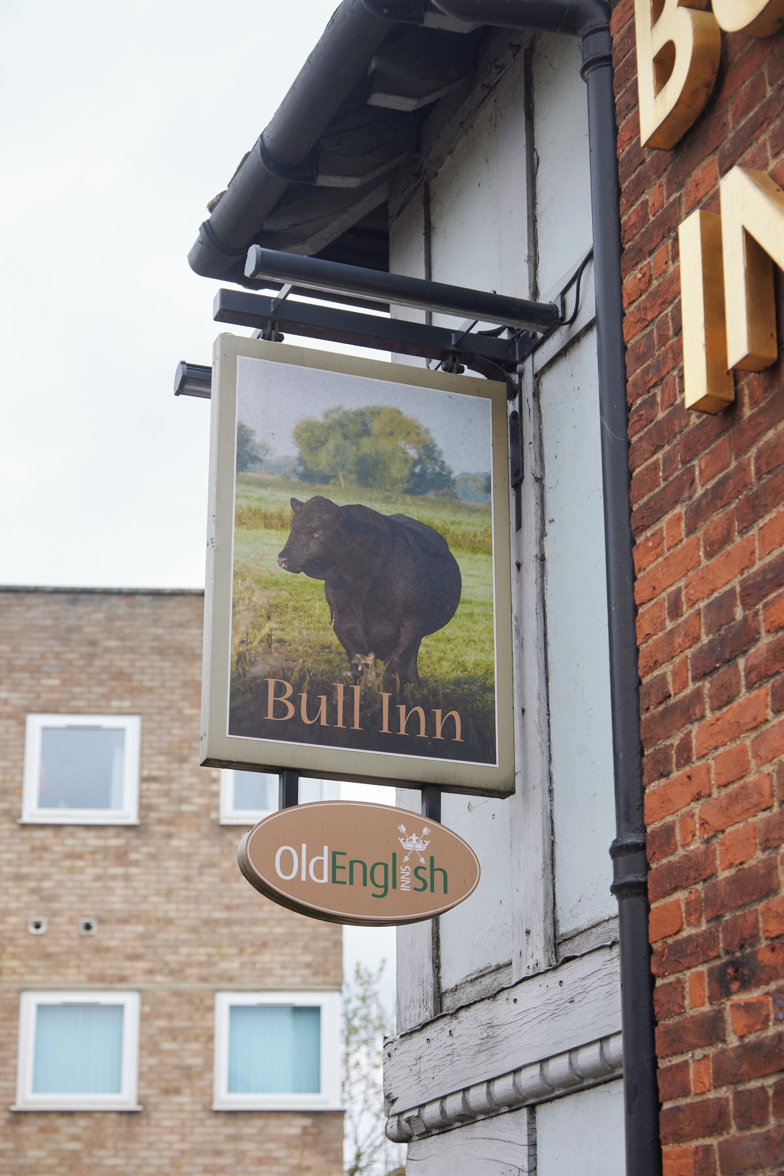 A sign for 'Bull Inn' with a cow illustration and 'Old English' text below.