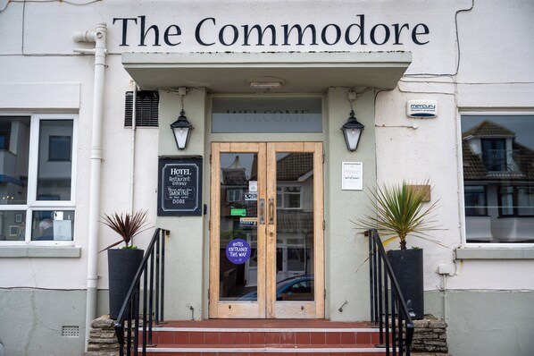 The Commodore hotel entrance with a signboard, a welcome sign, and a blue directional sign. - Commodore Hotel Bournemouth by Greene King Inns (Bournemouth)
