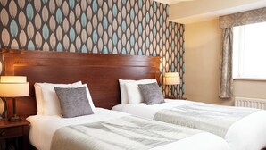 A hotel room with two beds, wooden headboards, and patterned wallpaper. - Coleshill Hotel by Greene King Inns (Birmingham)