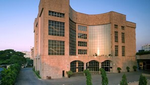 A large, modern building with a curved facade and a sign reading "THE RESIDENCY". - The Residency Mumbai (GUNDAVALI, ANDHERI)