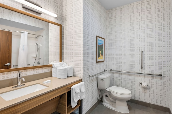 A modern bathroom with a sink, mirror, toilet, and shower. - Hampton Inn Monticello (Monticello)