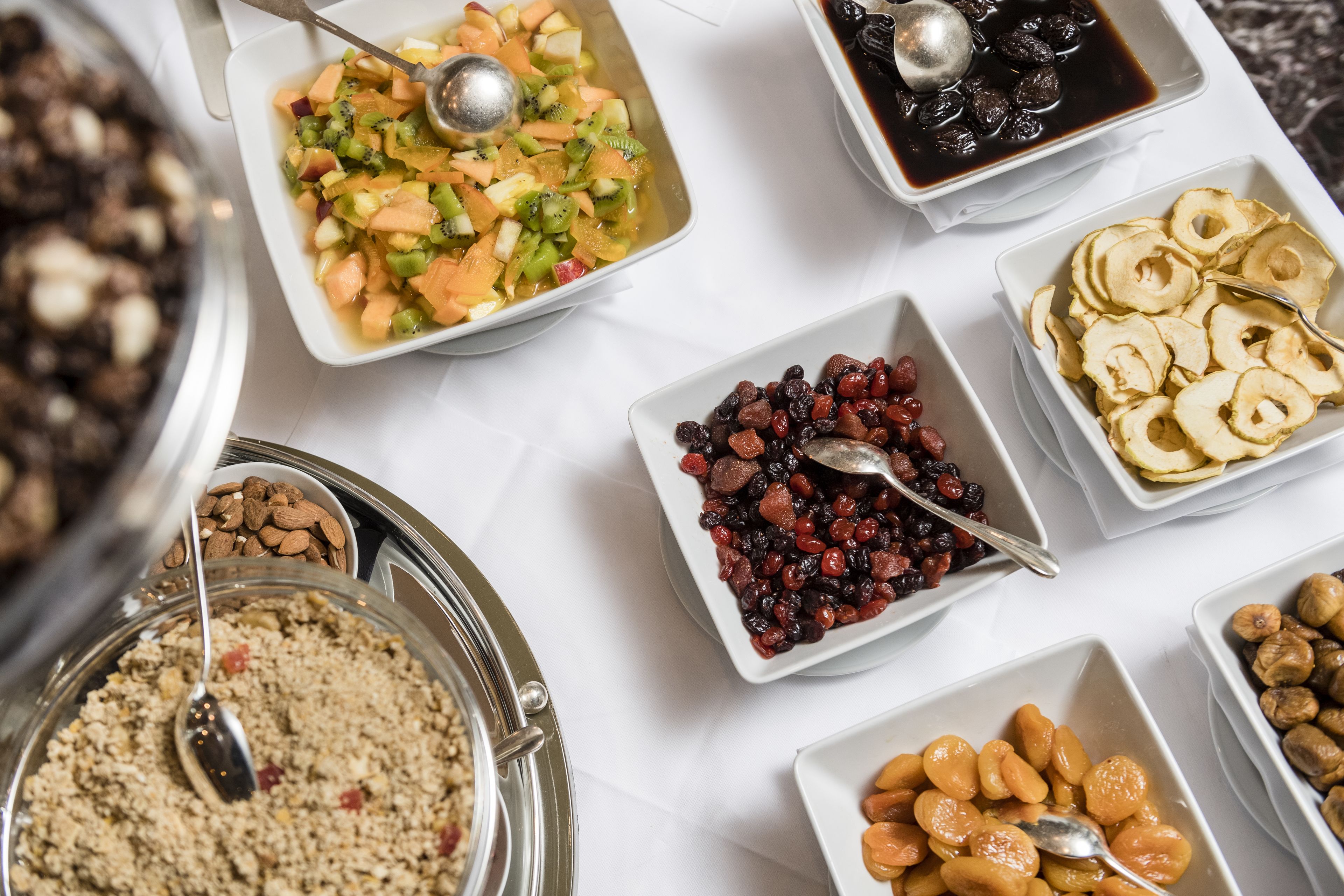 A variety of food items in bowls on a table.