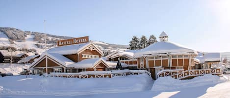 A snow-covered building with a sign reading "Hafjell Hotel."