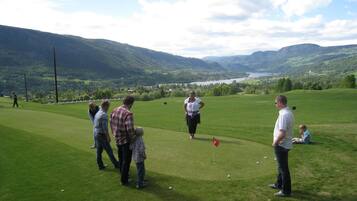 Enjoy a round of golf amidst rolling hills and a serene lake.