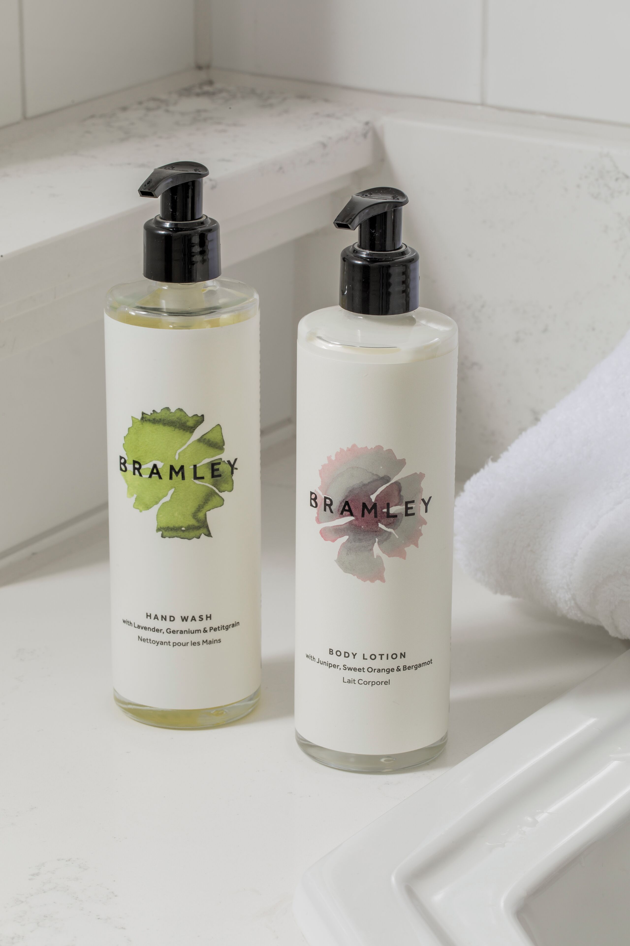 Two bottles of Bramble hand wash and body lotion on a bathroom counter.