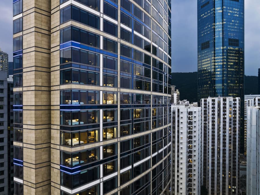 A high-rise building with a curved facade, large windows, and a modern architectural design.