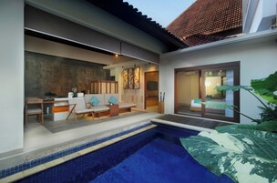 A modern house with a swimming pool, a dining area, and a bedroom with a sliding glass door.