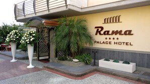 The exterior of Rama Palace Hotel with a large sign, a gated entrance, and potted plants. - Rama Palace Hotel (Casalnuovo di Napoli)