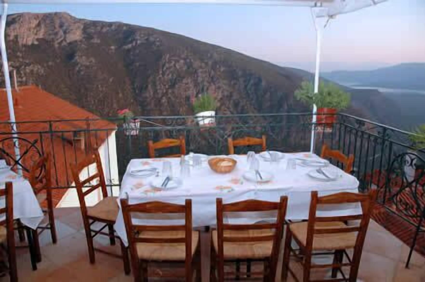 A table set for four with a mountain view in the background.