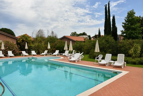 Outdoor pool, open 10:00 AM to 7:00 PM, pool umbrellas, pool loungers