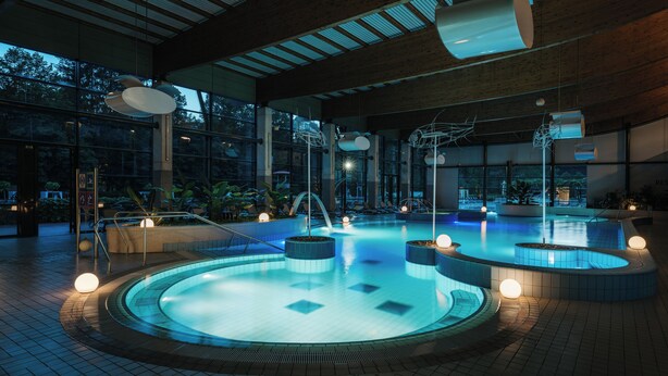 A modern indoor pool area with multiple pools, lounge chairs, and a wooden ceiling. - Hotel Kristal - Terme Krka (Dolenjske Toplice)