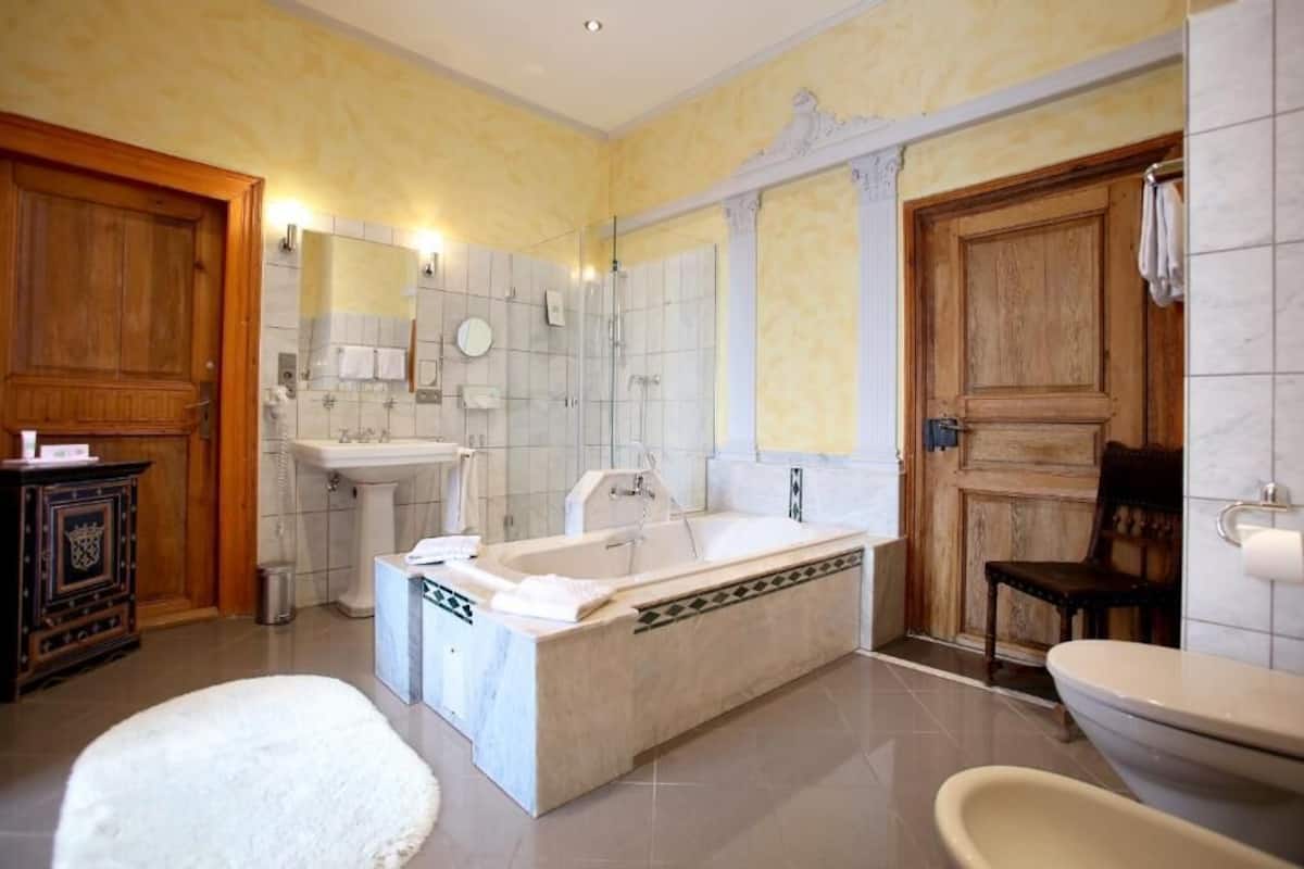 shower, hair dryer, slippers, towels