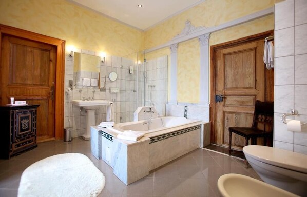 Un baño con bañera, lavamanos e inodoro.