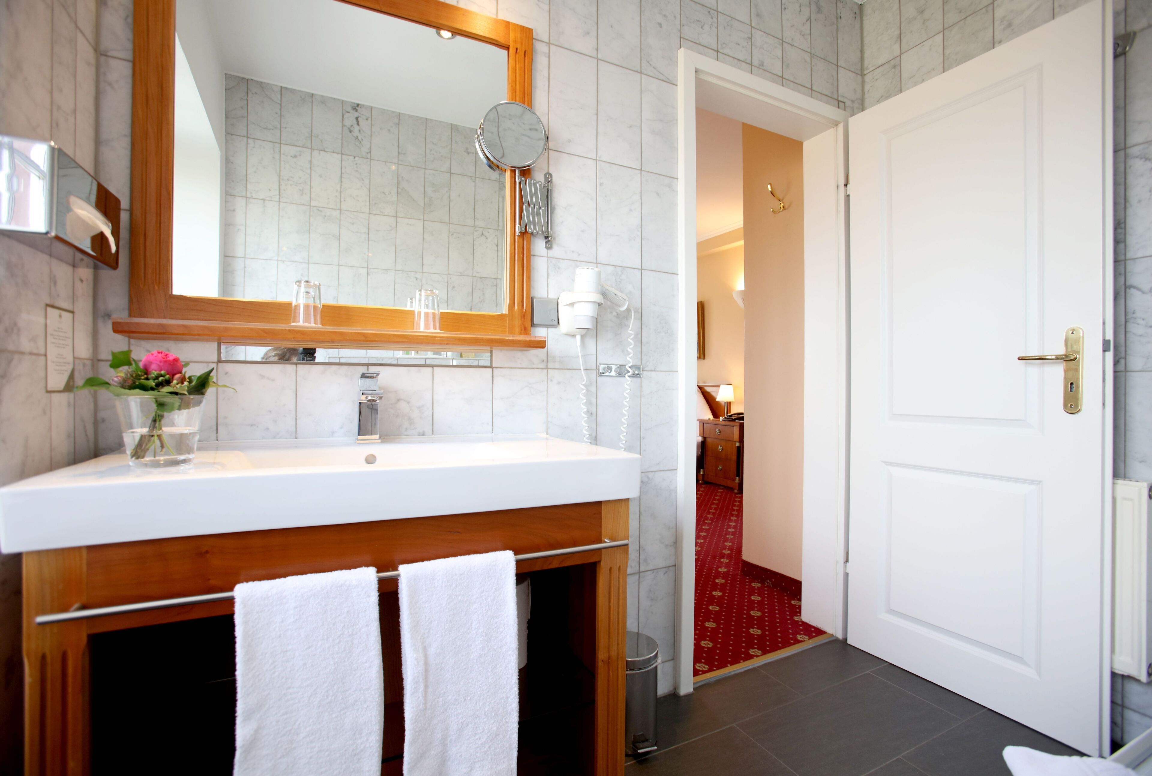 shower, hair dryer, slippers, towels