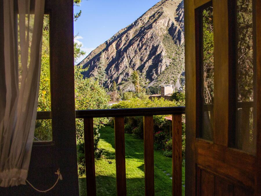 A view from a balcony with a mountain backdrop.