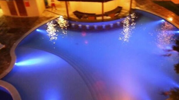 A swimming pool with a circular structure in the center, surrounded by a low wall. - CostaSol Pipa (Tibau do Sul)