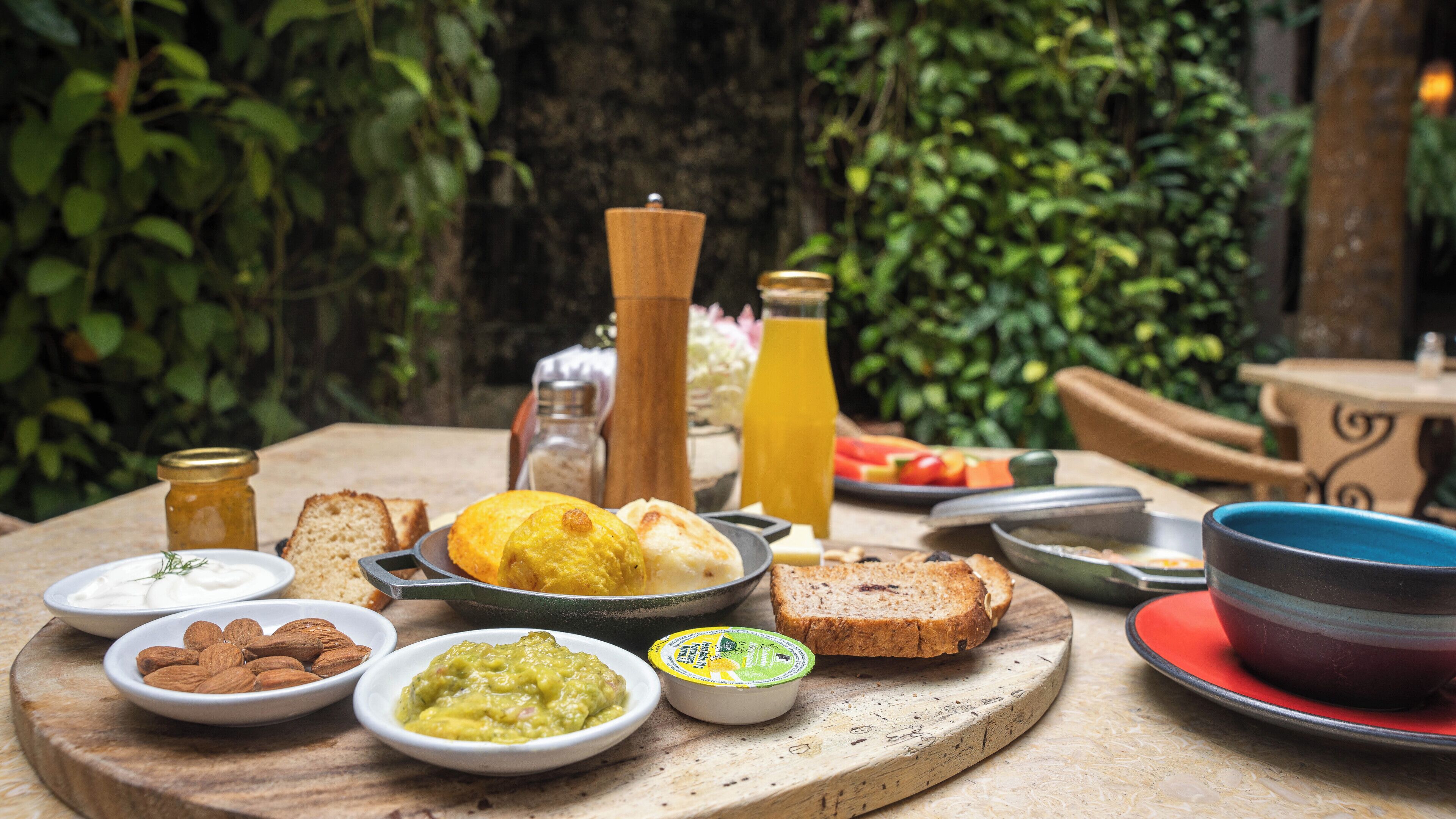 A breakfast table with various food items and condiments.