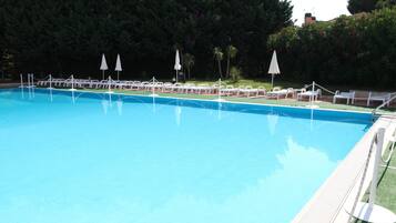 Seasonal outdoor pool, open 9:00 AM to 7:30 PM, pool umbrellas