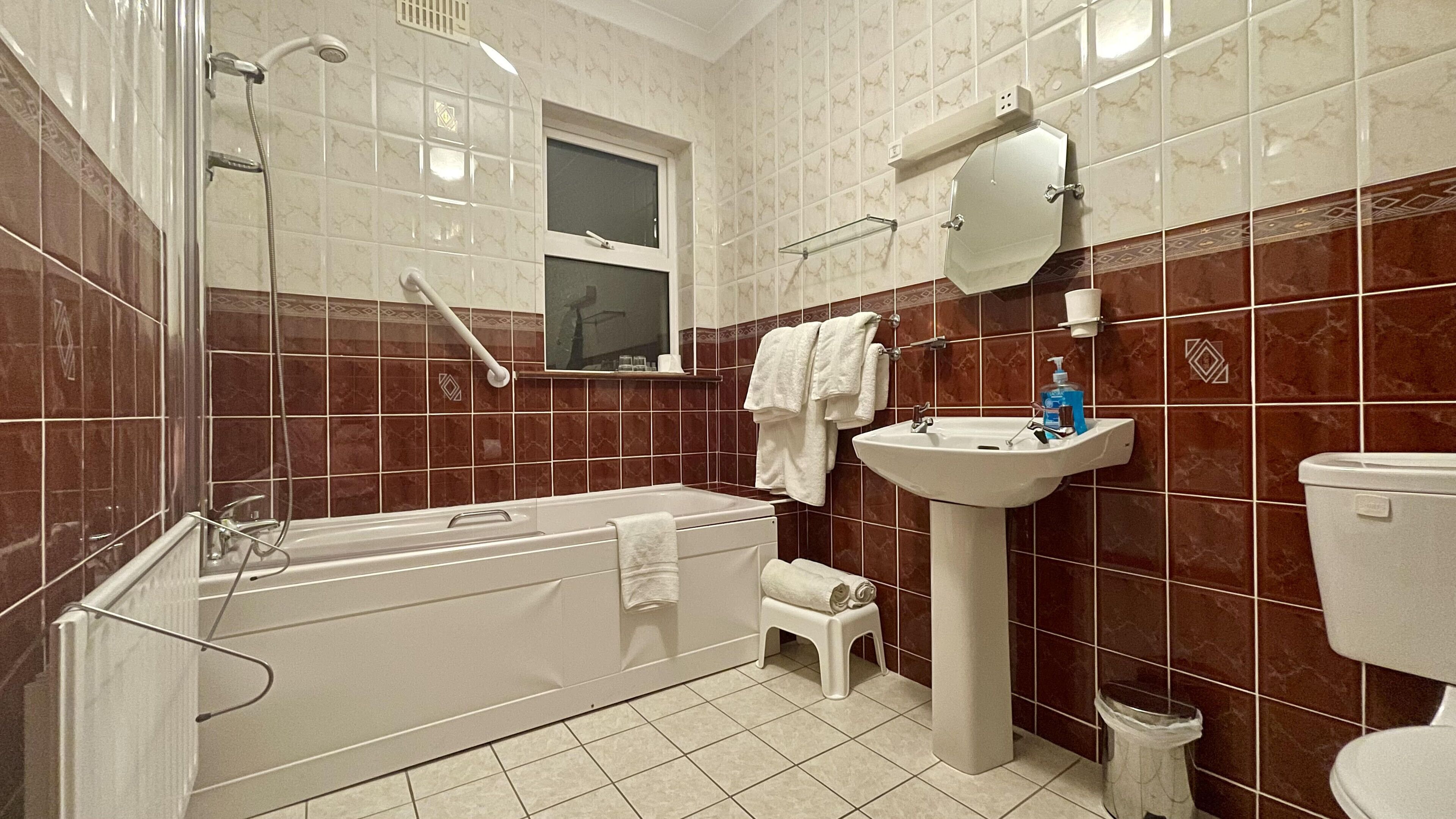 A bathroom with a bathtub, sink, and toilet.