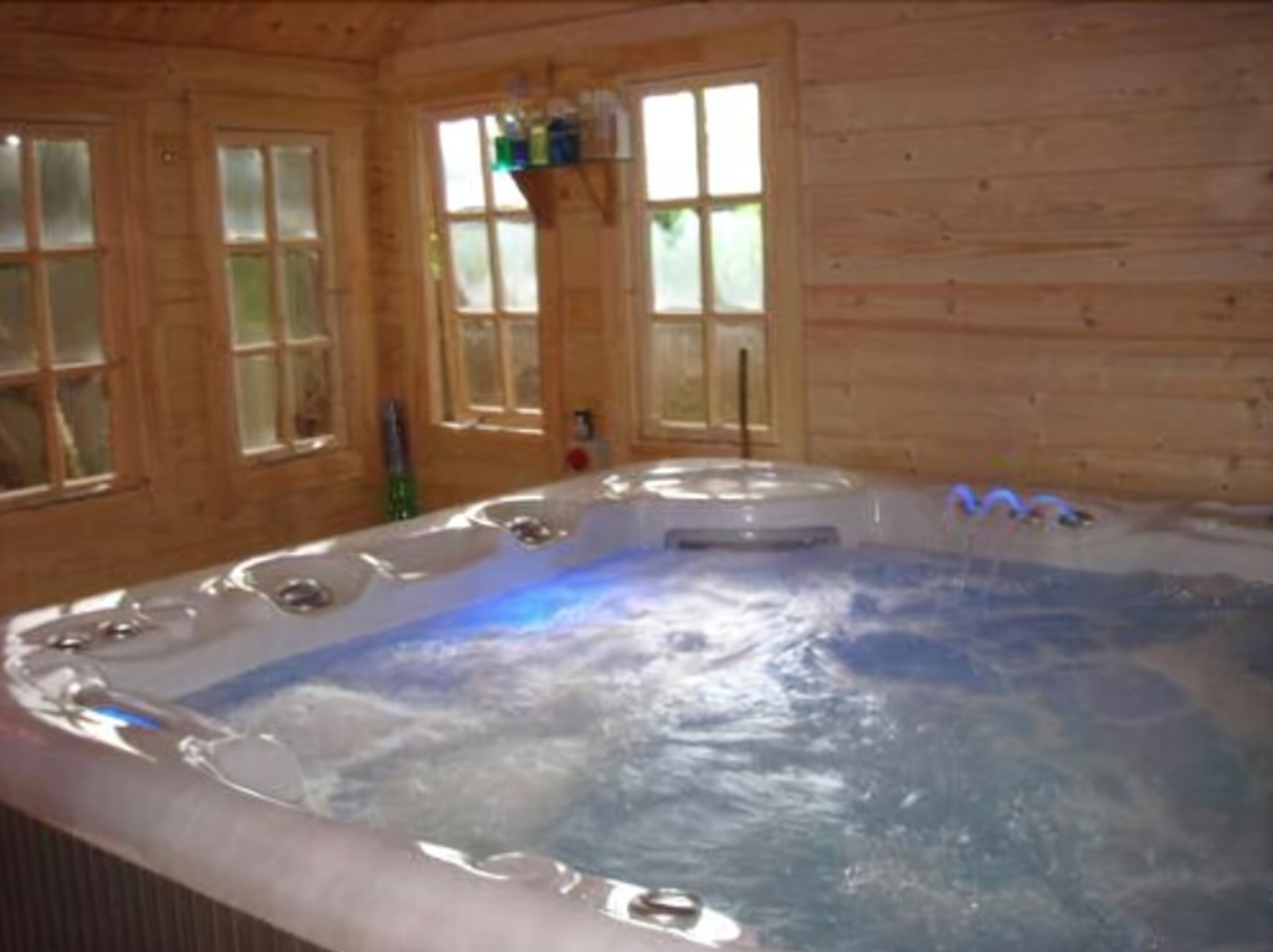 A wooden cabin with a hot tub.