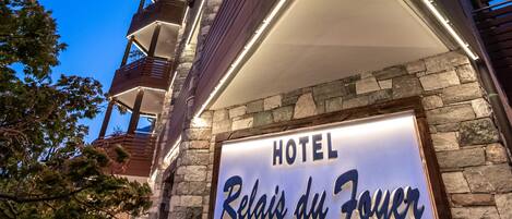 A hotel sign with "HOTEL Relais du Foyer" and a star rating of five stars.