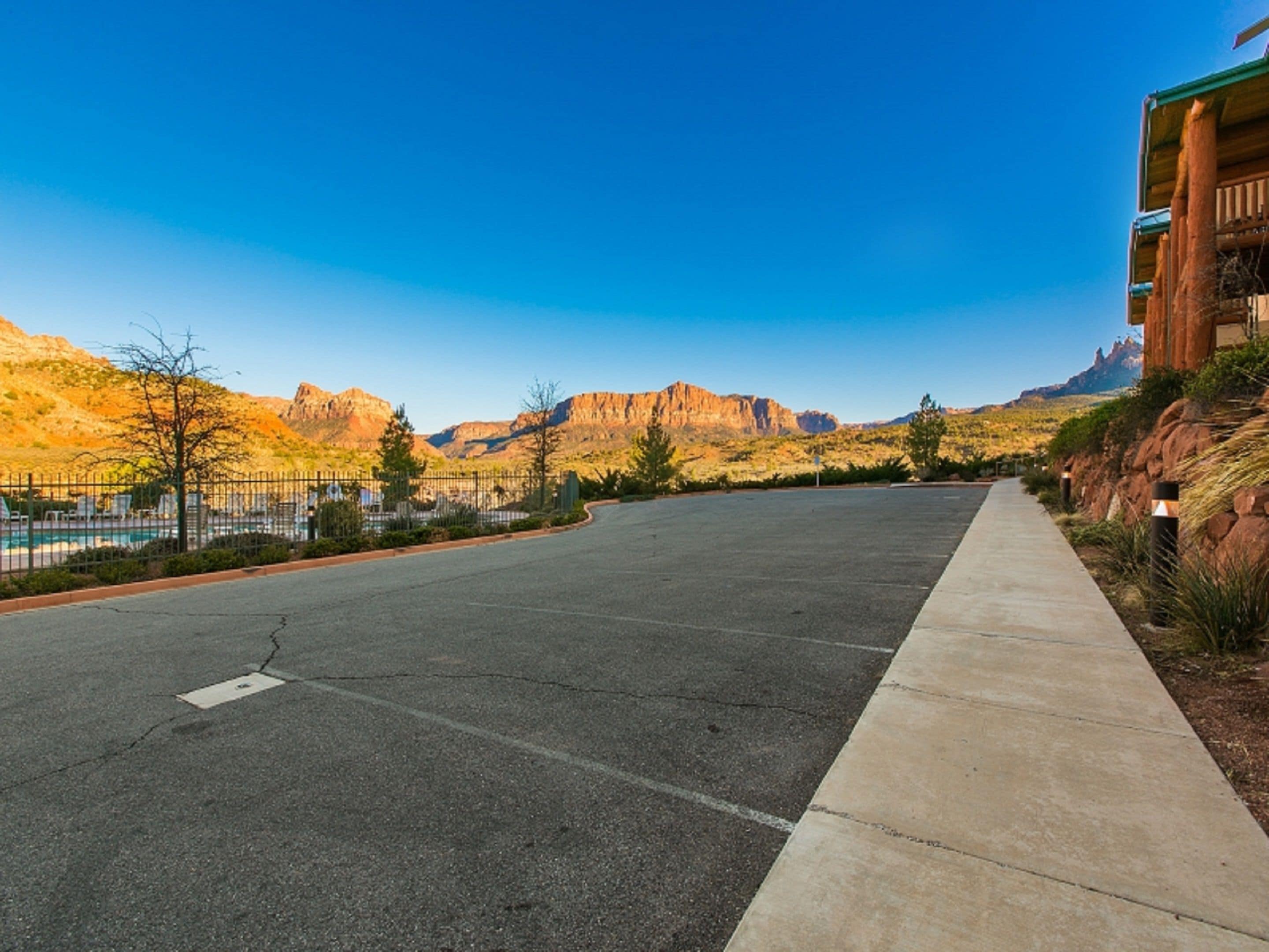 A parking lot with a clear view of mountains in the background.