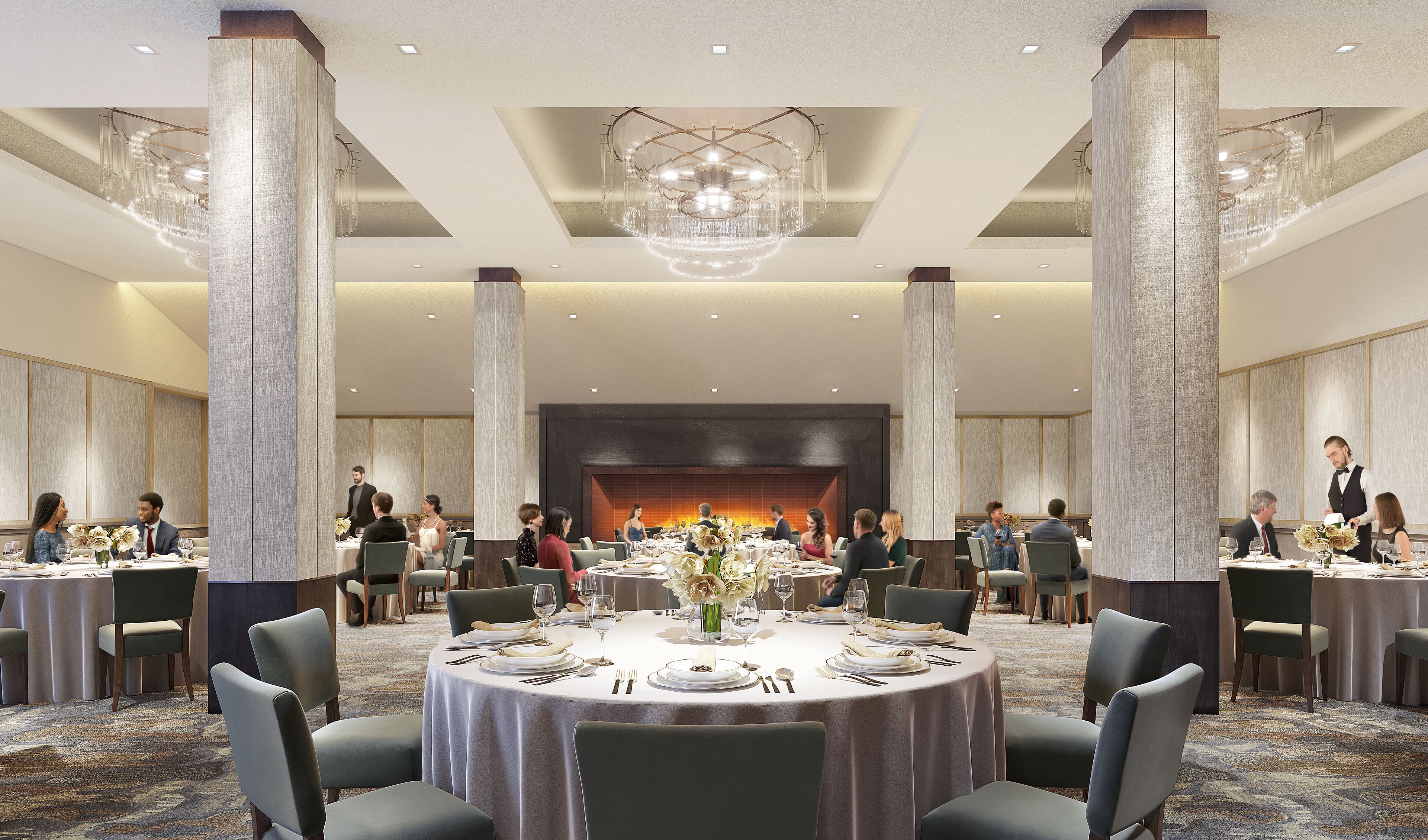 A spacious banquet hall with round tables, high ceilings, and a central fireplace.