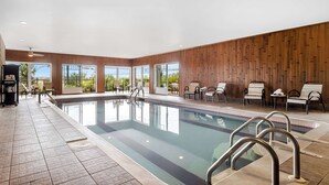 A modern indoor pool area with clear views, wooden panel walls, and multiple seating areas. - Best Western Plus Mont-Laurier (Mont-Laurier)