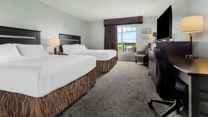A hotel room with two beds, a desk with a chair, a TV, and a view of the outdoors. - Best Western Plus Mont-Laurier (Mont-Laurier)