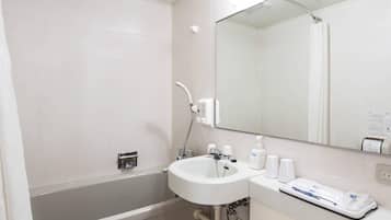 A modern bathroom with a bathtub, a sink, and a mirror.