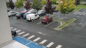 A parking lot with marked disabled parking spaces and a pedestrian crossing. - Premiere Classe Epernay (Epernay)