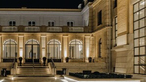 A grand building with a symmetrical facade, large arched windows, and a central staircase leading to a balcony. - Premiere Classe Epernay (Epernay)
