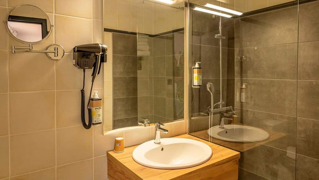bathtub, eco-friendly toiletries, hair dryer, towels