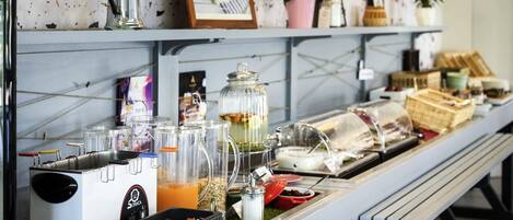 A buffet setup with various food items and condiments.