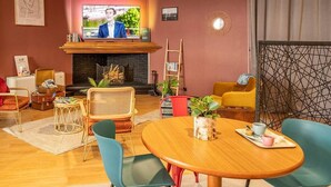 A cozy living room with a fireplace, comfortable seating, and a television. - Greet Hotel Castres Saïx (Saix)