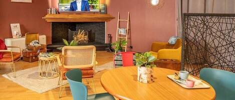 A cozy living room with a fireplace, comfortable seating, and a television.