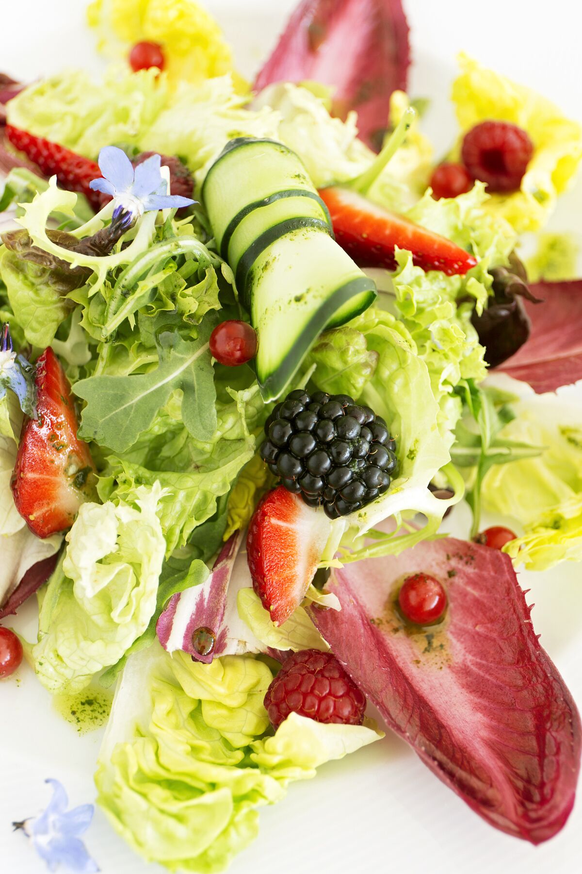 A salad with various vegetables and fruits.