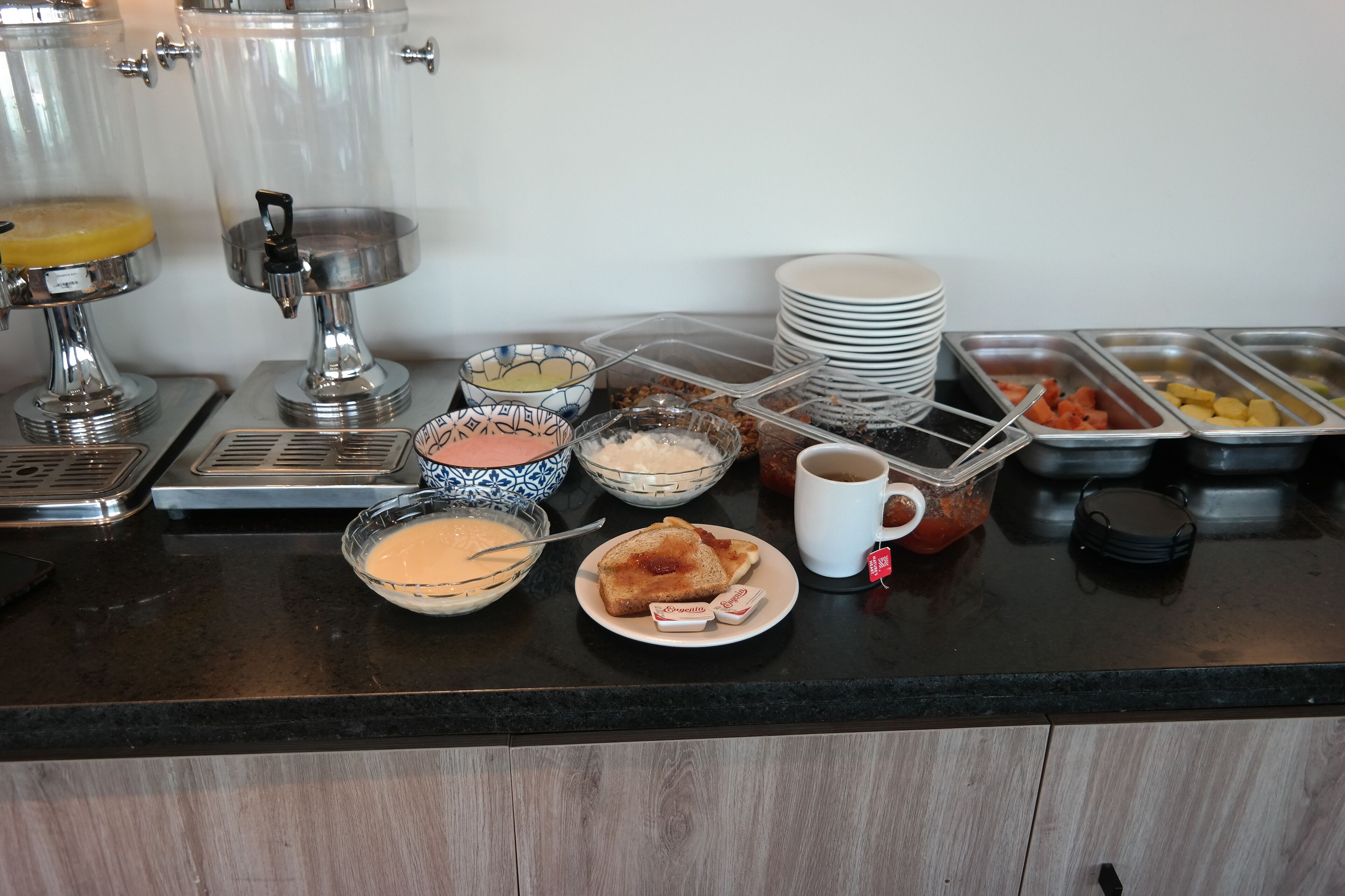 A buffet setup with various food items and beverages.