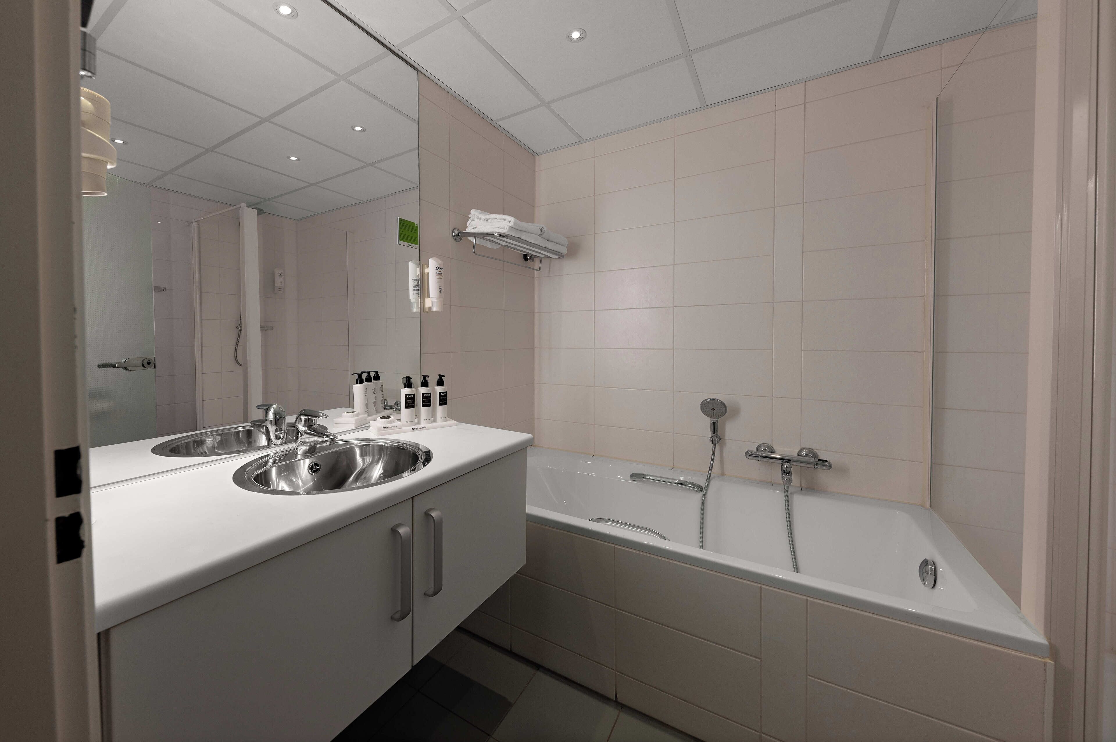 separate bathtub and shower, eco-friendly toiletries, hair dryer, towels