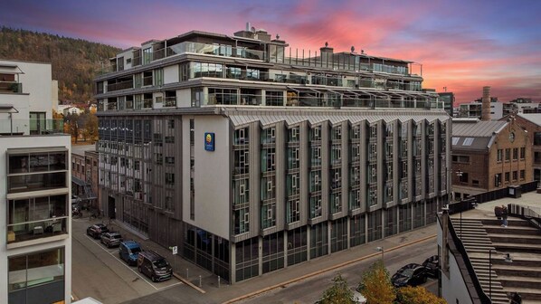 A modern multi-story building with large windows and a prominent sign. - Comfort Hotel Union Brygge - Drammen (Drammen)