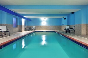 An indoor swimming pool with clear water, surrounded by blue walls and a tiled floor. - Holiday Inn Express Hotel & Suites AMITE by IHG (Amite)